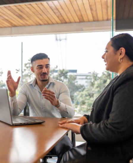 Two people talking in a conference room