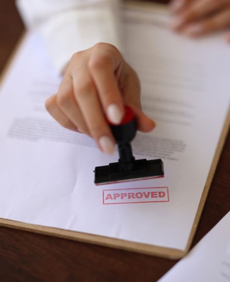 Someone stamping approved on a document